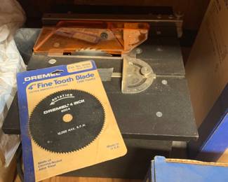 Vintage Dremel table saw with orange blade guard and a packaged Dremel 4-inch 100-tooth fine tooth blade (Cat. No. 8004).