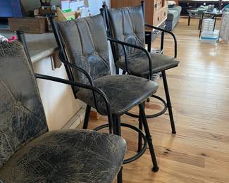Three counter height swivel chairs