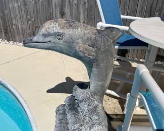 Large, stone breaching dolphin