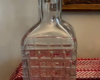 Vintage decorative clear glass decanter featuring a geometric patterned body and matching glass stopper.
