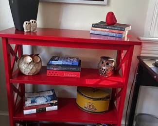 Eye-catching red painted bookshelf with four open display levels and decorative X-braced sides. Perfect for books, collectibles, plants, or colorful display storage.
