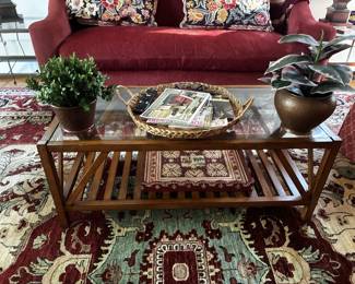 Handsome wood coffee table with a glass top and open slatted shelf below. A practical piece with plenty of surface space and a warm traditional look, perfect for a living room or family room.