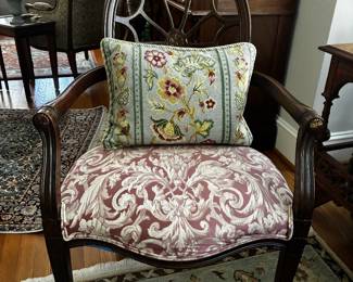 Decorative carved wood armchair with upholstered seat and back. Traditional styling with substantial wood frame.