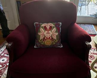 Rich burgundy upholstered lounge chair with exposed wood arms and a classic traditional look. A comfortable, substantial accent chair that would work beautifully in a living room, den, office, or reading corner