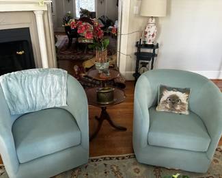 Matching pair of pale aqua upholstered barrel chairs with rounded backs and arms. Sold as a pair.