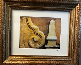 Architectural artwork featuring classical stone details, presented in an ornate, antiqued gold-tone frame.