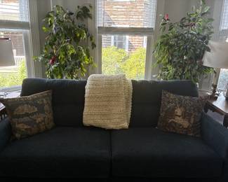 Large dark teal/blue upholstered sofa with clean, classic lines. Substantial living-room seating piece.
