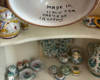Underside marking reading "Made in Italy for Creme de la Creme," documenting the origin and distribution of a ceramic piece in the collection.
