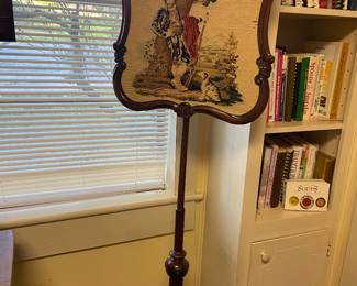 Antique needlepoint fire screen.