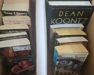 Books & Novels Assorted paperback and hardcover books, including Dean Koontz, Tom Clancy and Star Wars novels.