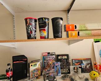 Superhero & Pop Culture Collectibles Marvel and DC collectibles. Thor and Captain America memorabilia. Hit-Girl graphic novel. Superhero drinking cups. Metallica CD. Collectible glasses and sports memorabilia.