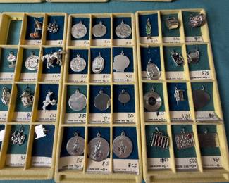 R.L. Griffith & Son Charms marked sterling. Some are slightly attracted to magnet, most not. Tested with 18k acid and showed sterling. Just full transparency to make choice. 