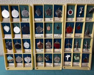 R.L. Griffith & Son Charms marked sterling. Some are slightly attracted to magnet, most not. Tested with 18k acid and showed sterling. Just full transparency to make choice. 