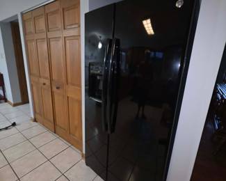 side by side black refrigerator