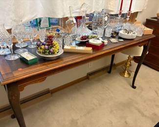 Library table loaded with crystal  in the dining room