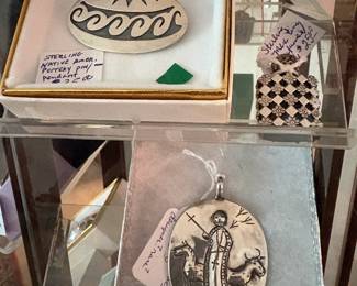 Some of the sterling items in 2 different rotating cases