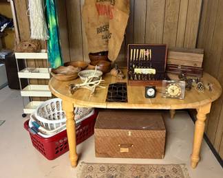 Diningroom Table with 1 Leaf; Grass Skirts; Wooden Bowls; Gold Vermeil Flatware by Cosmos; Silverware Cases; Laundry Baskets