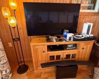 Entertainment Center Cabinet; 55" Samsung UHDTV Series 6 TV; Floor Lamp; HDMI Cables; Apple TV4K; Bose Universal Remote; Bose Solo Sound System; Samsung Surround Sound (Sunroom)