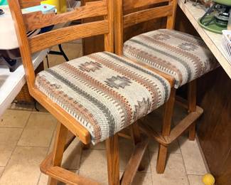 Heavy Wood Western Barstool Pair Overall good condition but one seat does have a small bit of tearing on the side. Seat measures 18” x 16” 30” tall to seat