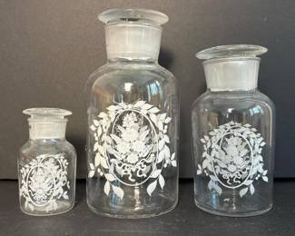 152 trioofglassapothecaryjarswithflora