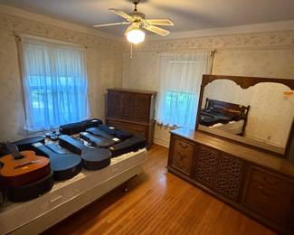 Dresser with mirror, gentlemen’s chest, wooden headboard, bed, musical instruments