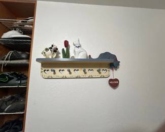 Country-style wooden wall coat rack with shelf, decorated with ceramic animal figurines and painted heart cutouts.