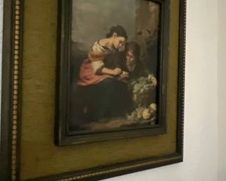 Framed reproduction print of Bartolomé Esteban Murillo's "The Little Fruit Seller" in a dark wooden frame with a fabric mat.