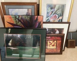 Collection of framed art prints and photographs, featuring floral art, landscapes, and portraits in various wood and metal frames.
