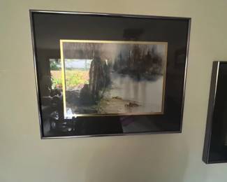 Framed watercolor landscape print featuring a misty forest scene, presented in a dark mat with gold accent inner trim and a metallic frame.