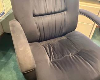 High-back plush swivel office chair upholstered in dark gray microfiber fabric, featuring padded armrests and a five-star caster base.