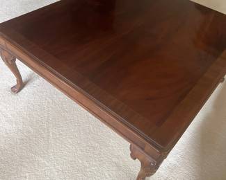 Traditional square mahogany coffee table featuring cabriole legs with ball-and-claw feet and a polished finish.