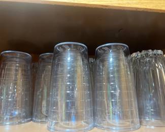 Collection of clear plastic highball tumblers and cut glass drinking glasses 