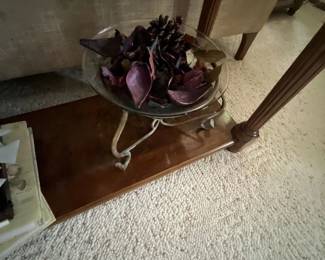 Glass potpourri bowl resting on a wrought-metal pedestal stand, filled with dried purple botanicals and pinecones.