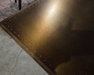 Brass clad top on 4 hands table 