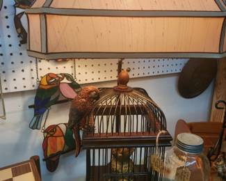 Very unusual lamp. Bird traps cat in cage