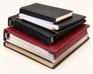 Binders & Albums ◆ Assorted black and burgundy binders and bound albums with pages.