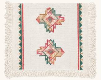 Southwest-style textile ◆ Cream fringed fabric with geometric motifs in muted pink, green, and tan.