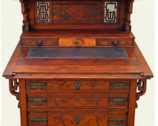 Ornate antique-style wooden writing desk with multiple drawers, carved decorative panels, geometric accents, raised gallery, and rich wood finish.