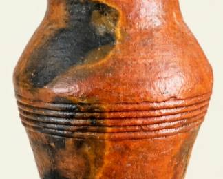 Large rustic pottery vase with warm reddish-brown and black glaze, flared rim, rounded body, and decorative horizontal ribbing.