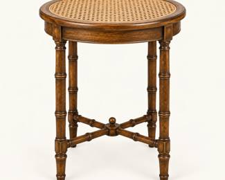 Cane-Top Accent Table ◆ Small round table with a woven cane top and dark wooden legs.