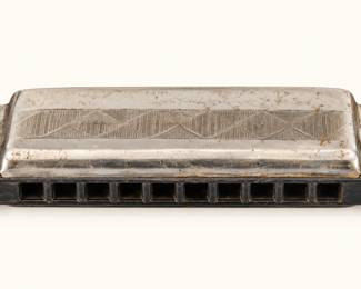 Vintage Metal Harmonica ◆ Silver-tone metal body with engraved geometric detailing and black comb. Shows age-related wear.