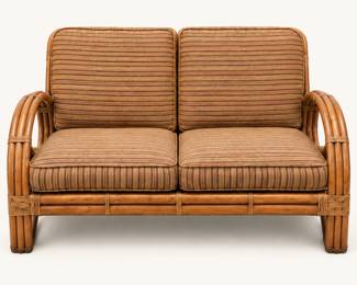 Rattan Loveseat ◆ Curved arms with striped seat and back cushions.