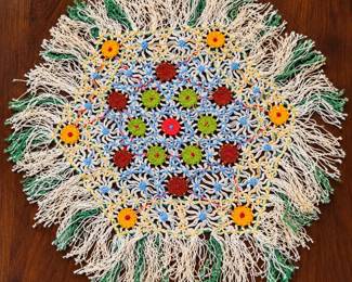Colorful Fringed Crochet Doily on Wood