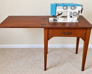 Vintage Sewing Machine on Wooden Cabinet