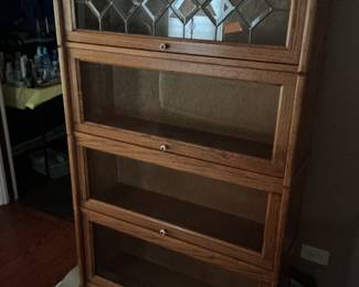 Barrister bookcase.  Four shelves.  Top piece has stain glass cover.  Presale $195