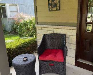 Two outdoor wicker chairs with red cushions.  Also 2 side tables