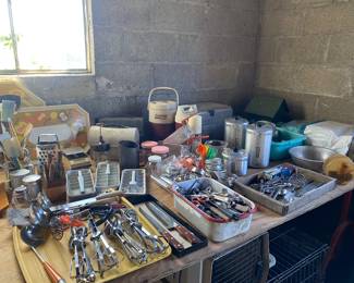 Silverware, MCM ice trays, a pile of measuring cups, vintage knifes, handmixers, graters and sieves
