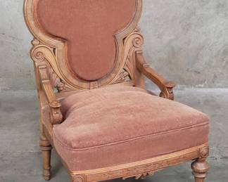 142 Lot 567 Antique upholstered carved walnut armchair with clover backrest