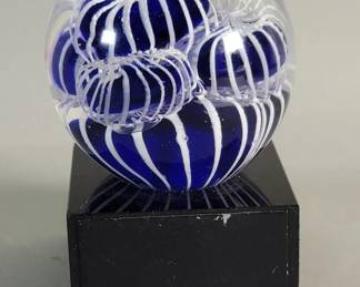 704 Lot 626 Hand blown glass paperweight on a glass base