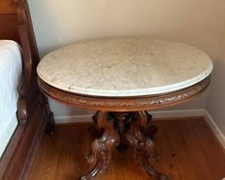 Antique Victorian Marble Top Oval Parlor Table with Ornately Carved Walnut Base  Casters